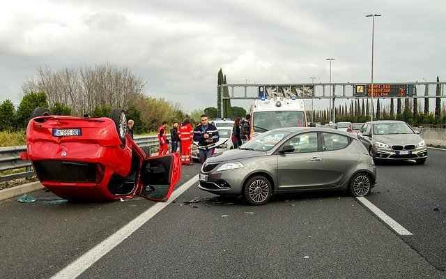 Car Accident Claims: A car accident scene, one car has overturned Car Accident Claims: A car accident scene, one car has overturned